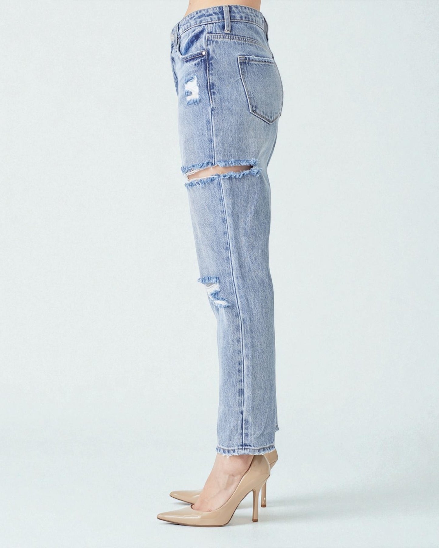 Light blue distressed jeans on a white background