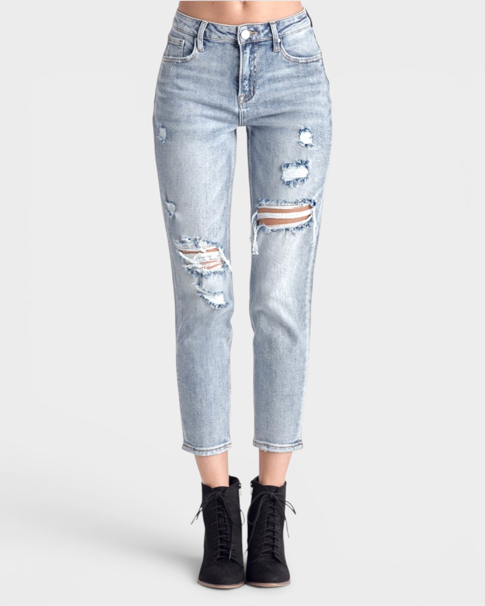 Light blue distressed jeans worn by a person on a white background