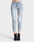 Light blue distressed jeans worn by a person on a white background