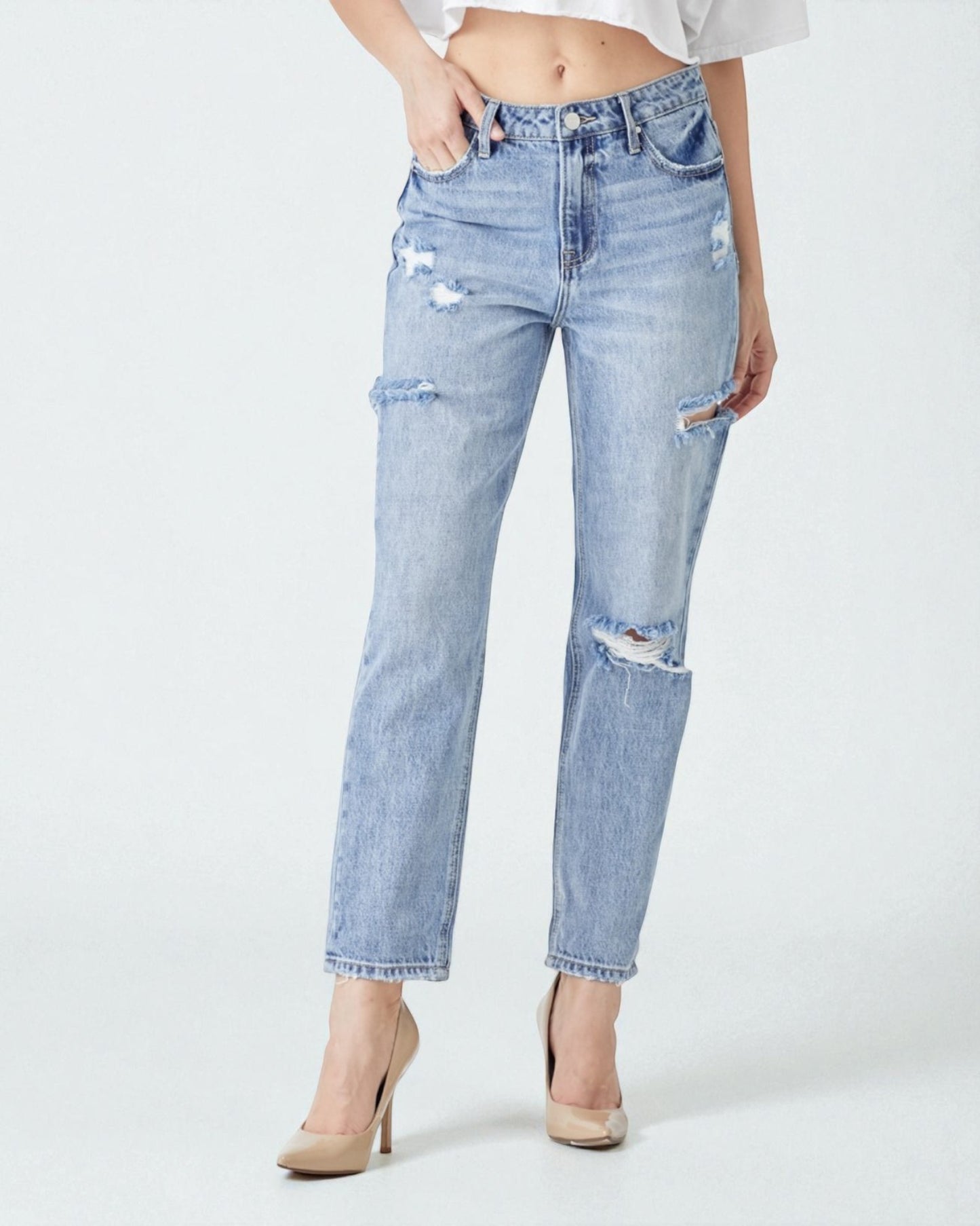 Light blue distressed jeans worn by a person on a white background