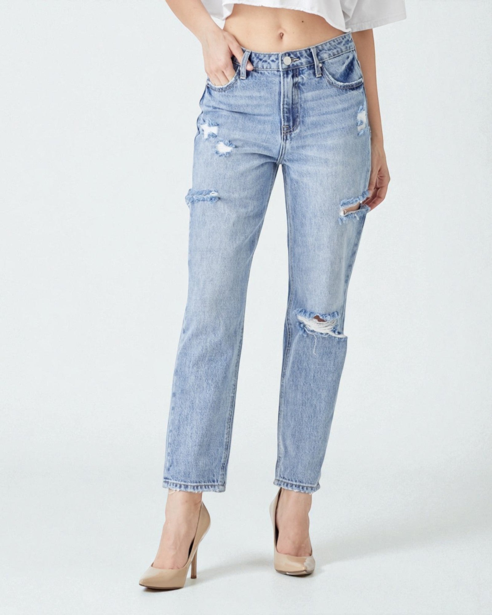 Light blue distressed jeans worn by a person on a white background