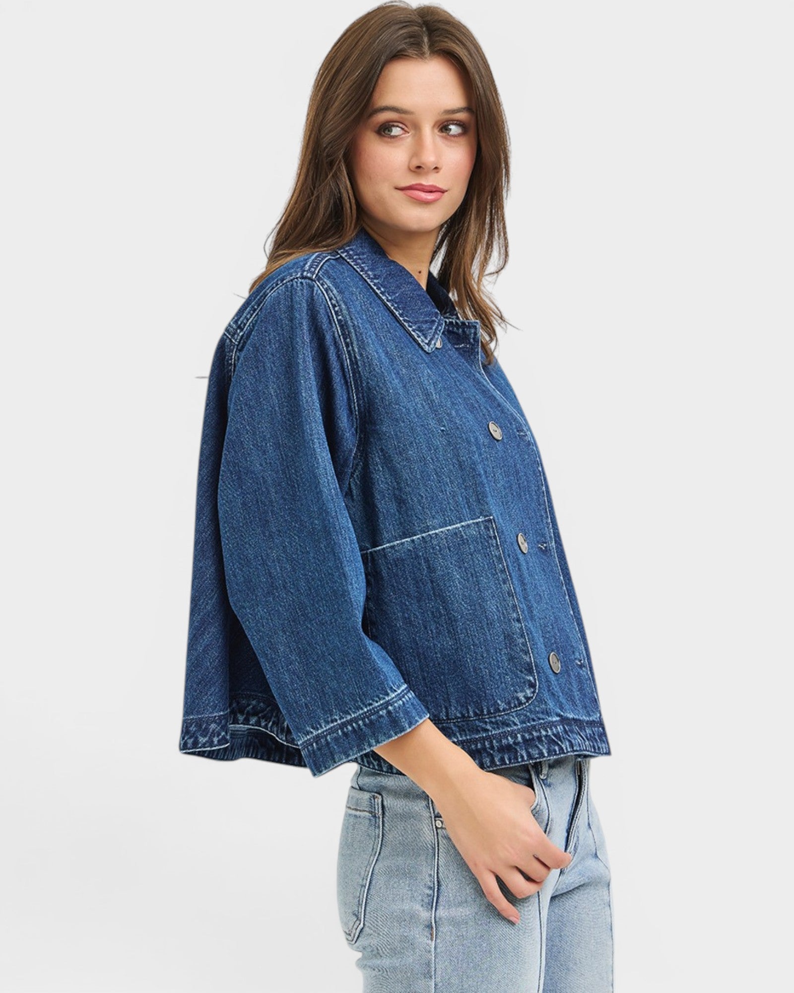 Woman wearing a blue denim jacket on a white background