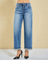 Blue jeans worn by a person on a beige background