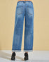 Blue jeans worn by a person on a beige background