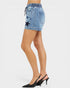 Denim skirt with star details worn by a person on a white background