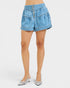Blue denim shorts worn by a person on a white background