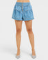 Blue denim shorts worn by a person on a white background