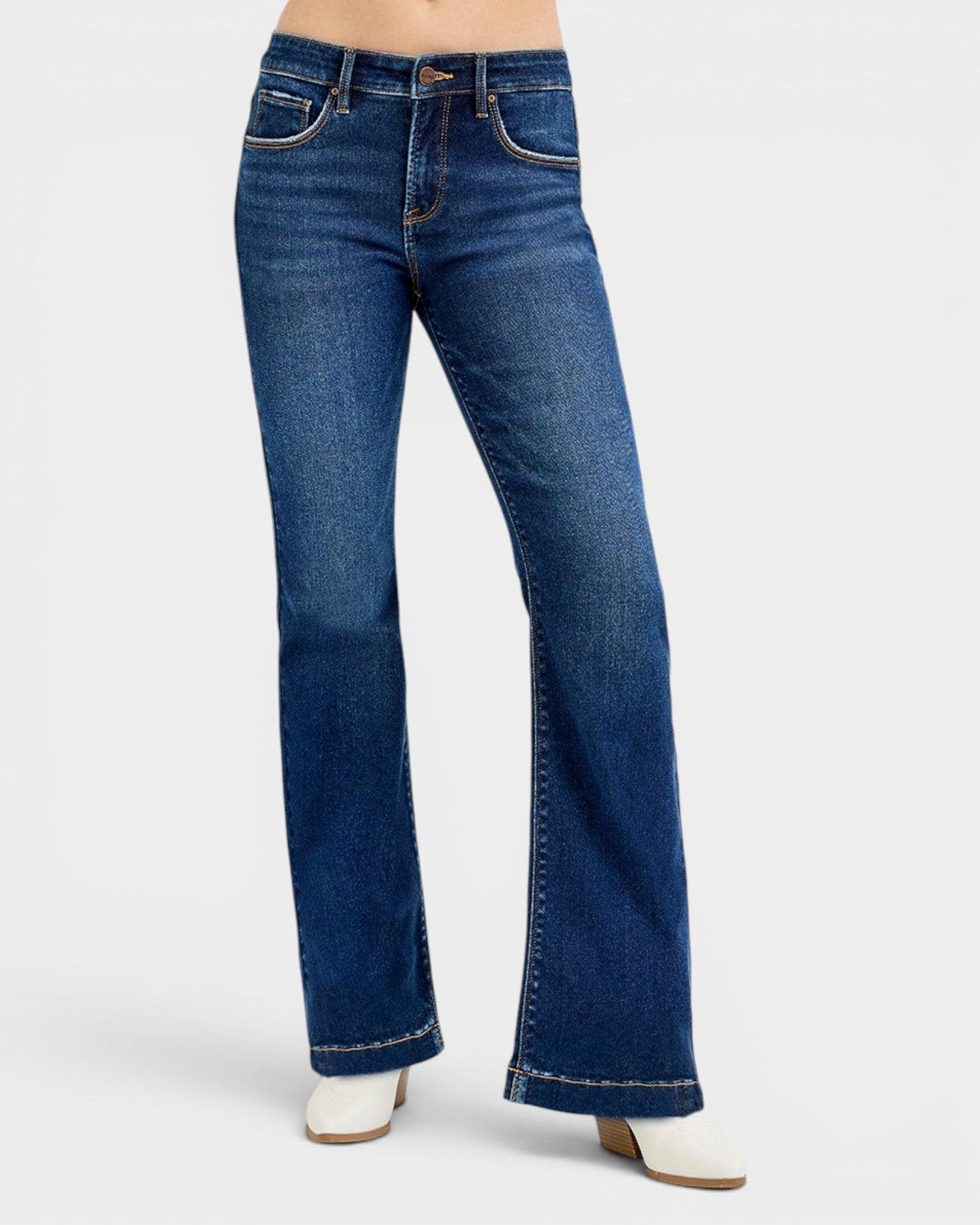 Blue jeans worn by a person on a white background