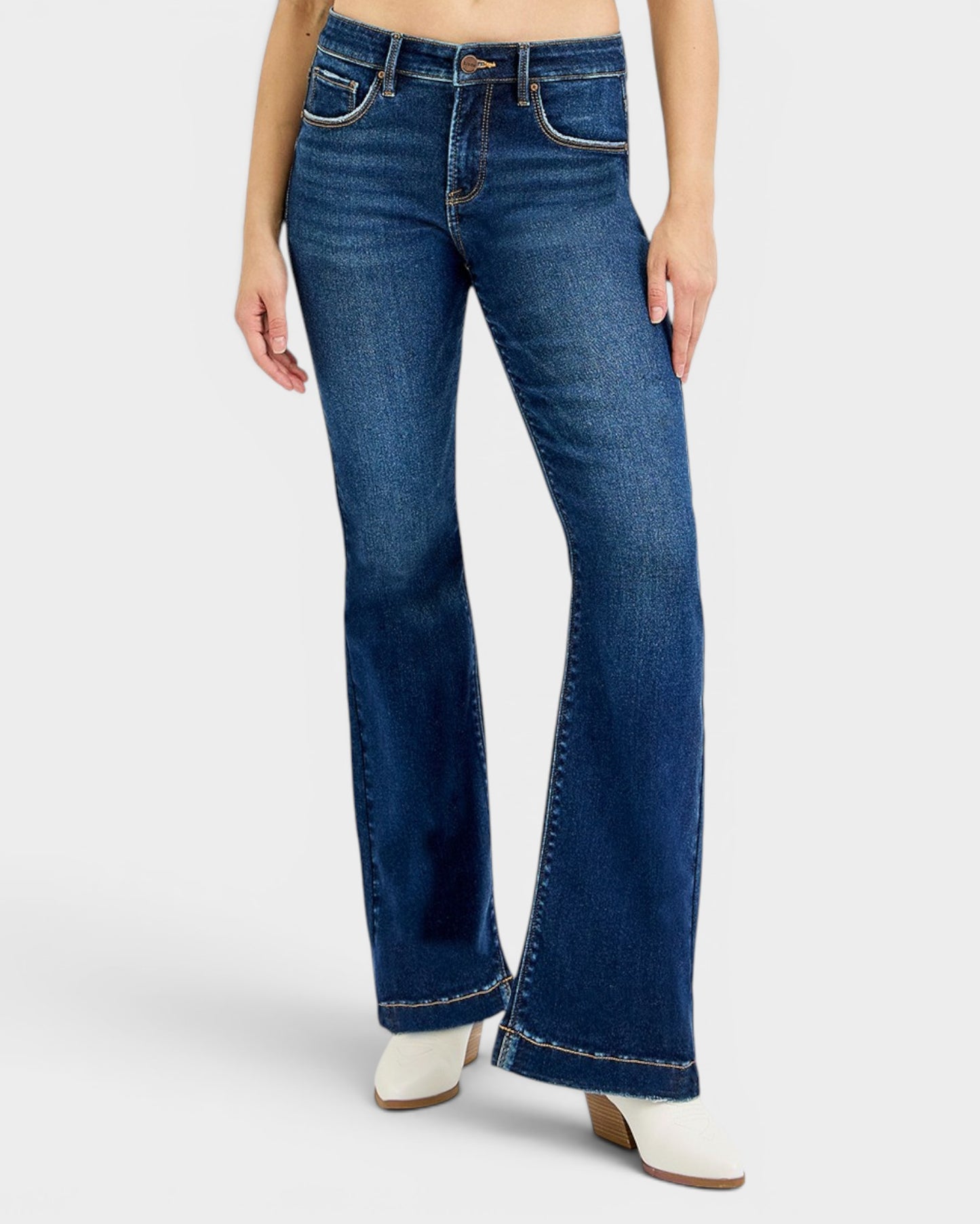 Blue flared jeans worn by a person on a white background