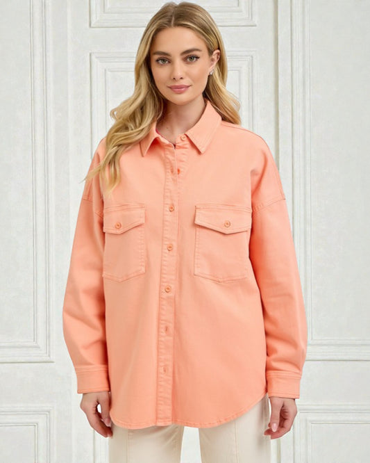 Woman wearing a peach-colored shirt against a white background