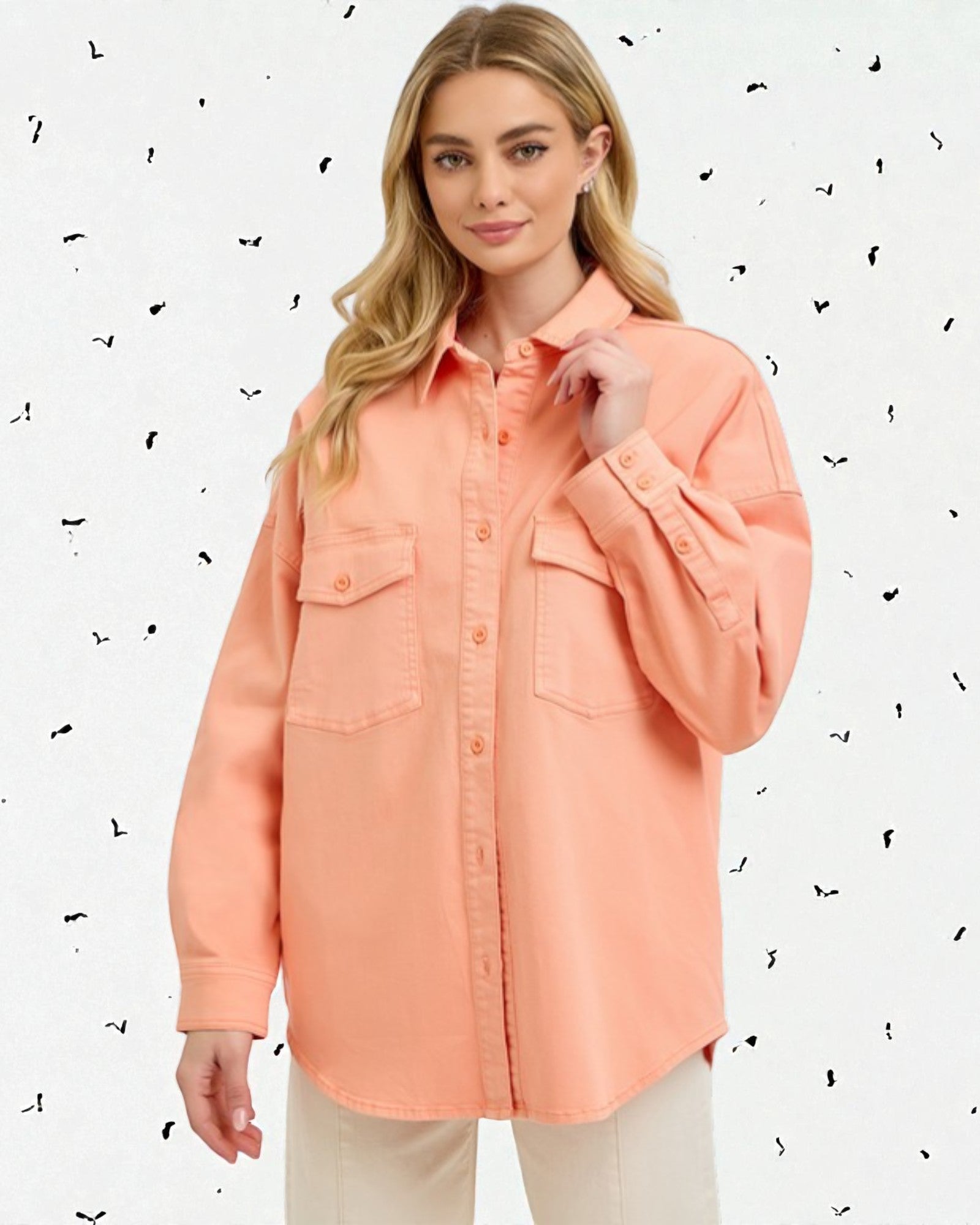 Woman wearing a peach-colored shirt against a light background