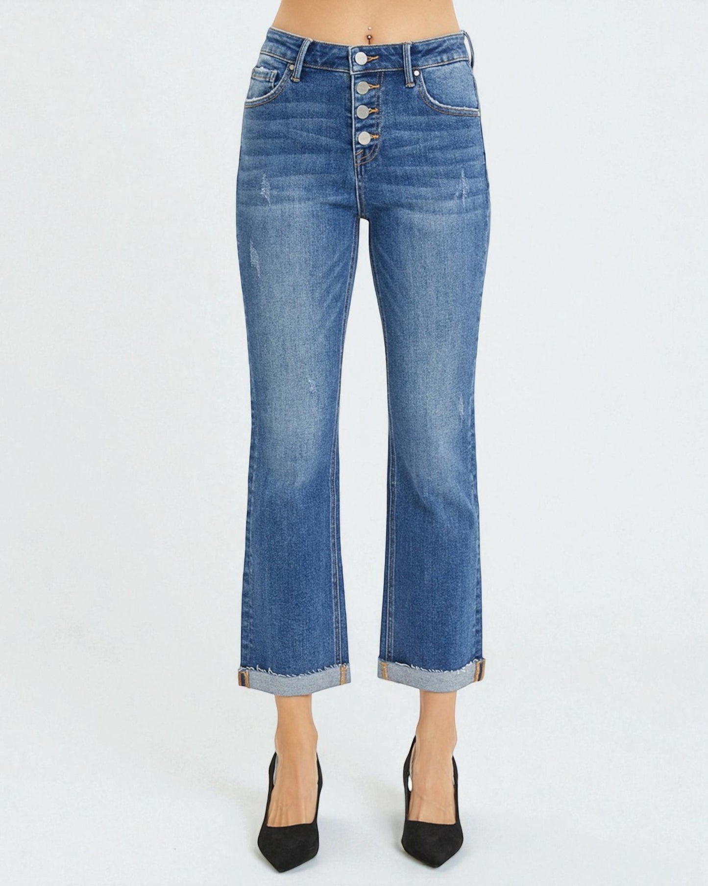 Blue jeans worn by a person on a white background