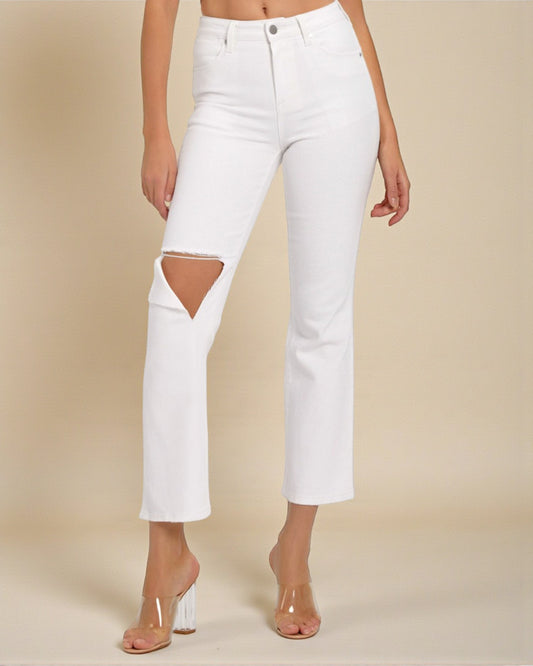 White jeans with cutout design on a beige background