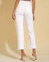 White pants worn by a person on a beige background