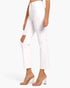 White cropped jeans with a diagonal cutout on the left leg, modeled with clear high-heel mules against a plain white background.
