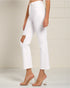 White pants with cut-out design worn by a person on a plain background