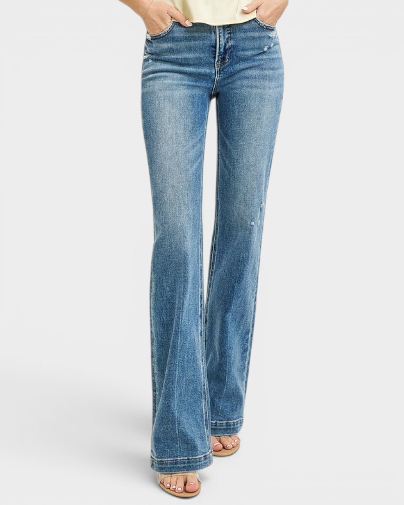 Blue jeans worn by a person on a white background