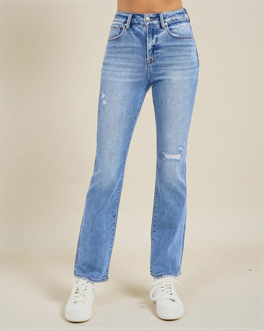 Blue jeans worn by a person on a beige background
