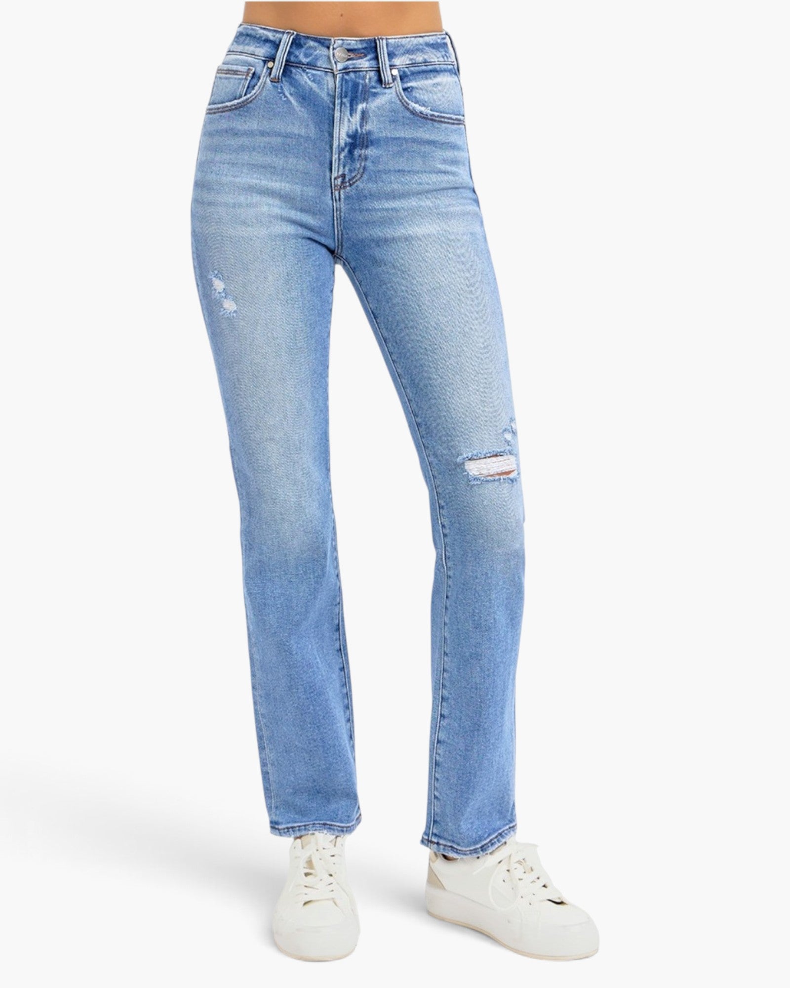 Light wash blue denim jeans with distressed details on the thighs and knees, shown on a model wearing white sneakers against a plain white background.