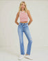 Woman wearing a red and white striped tank top and blue jeans on a plain background