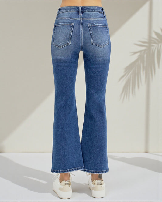 Blue jeans worn by a person on a white background