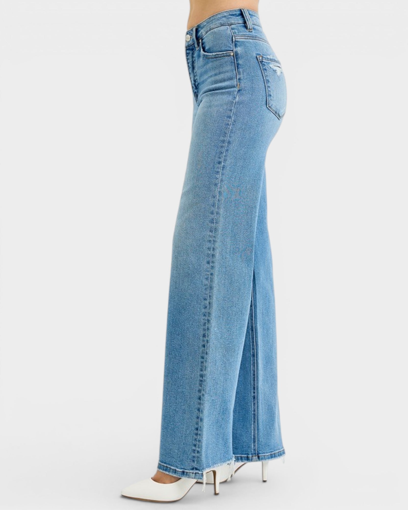 Blue jeans with a high slit on a white background