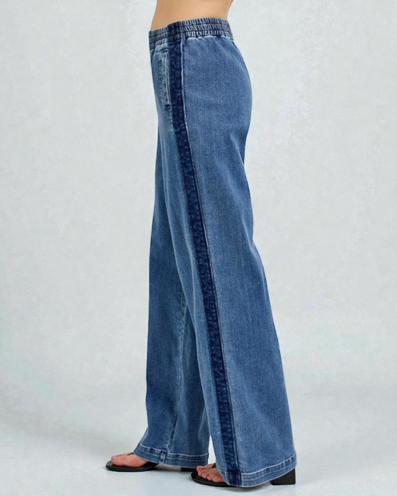 Blue jeans worn by a person on a white background