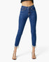 A model wearing high-waisted, skinny blue denim jeans with frayed hems, paired with clear high-heeled sandals, shown against a plain white studio background.