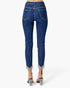 Rear view of a person wearing dark blue denim jeans with frayed hems and clear high-heeled sandals against a light gray studio background.