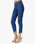 A model's lower body wearing high-waisted, cropped blue denim jeans with frayed hems and clear high-heel mules, shown against a plain white studio background.