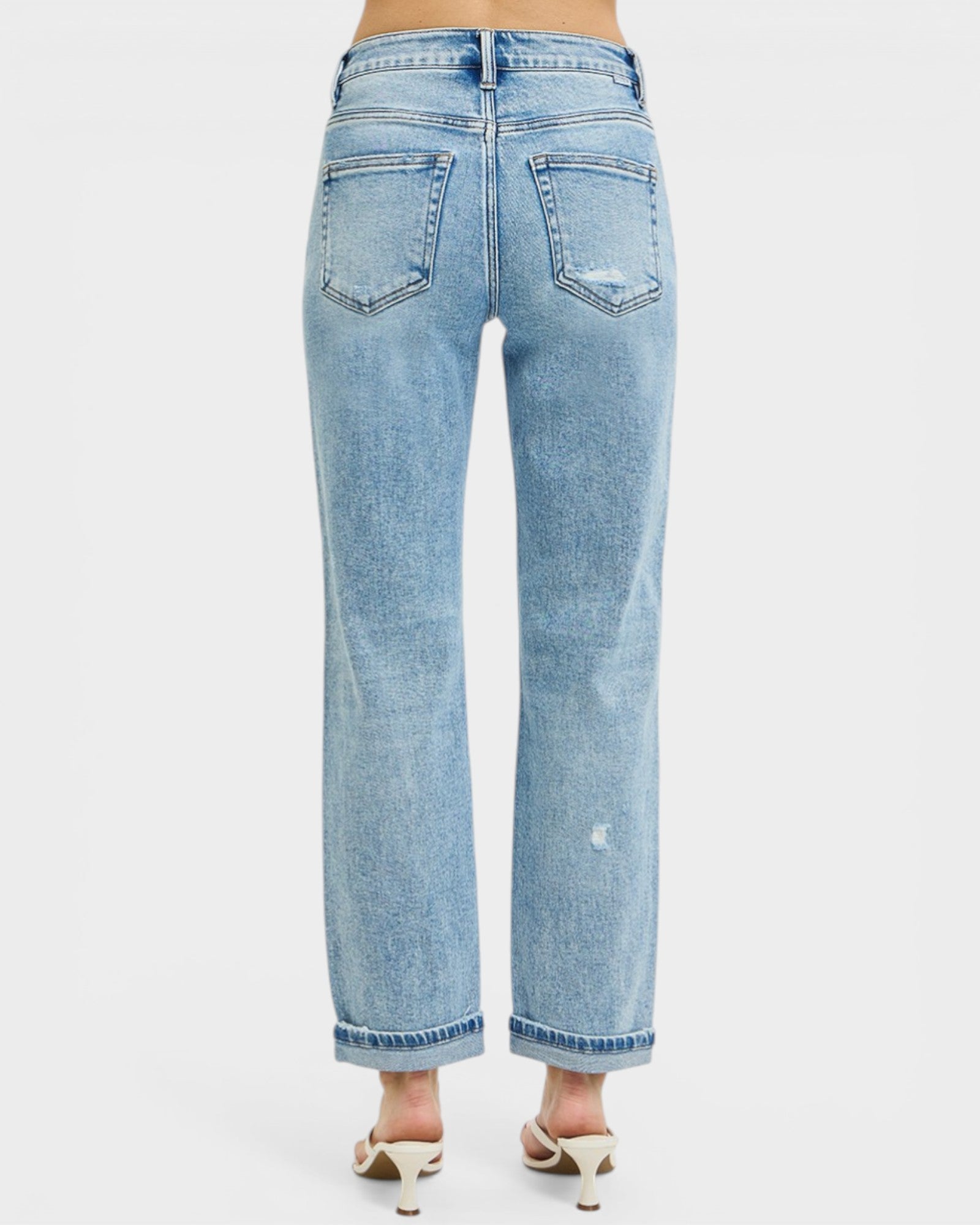 Light blue jeans worn by a person on a white background