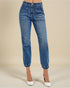 Blue jeans worn by a person on a beige background