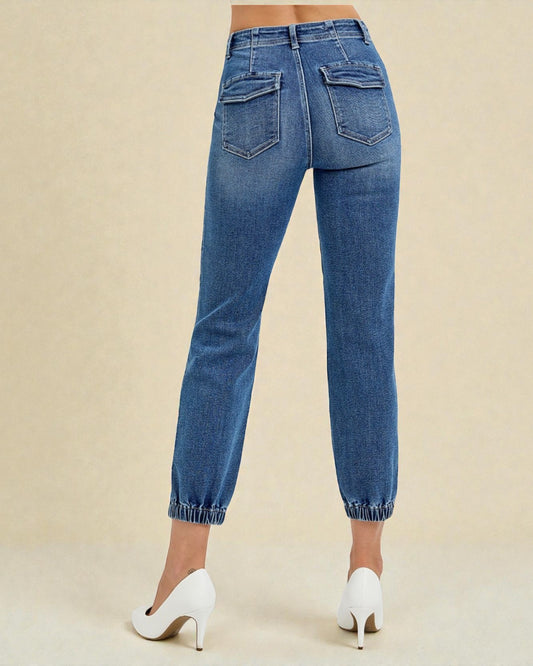 Blue jeans worn by a person on a beige background