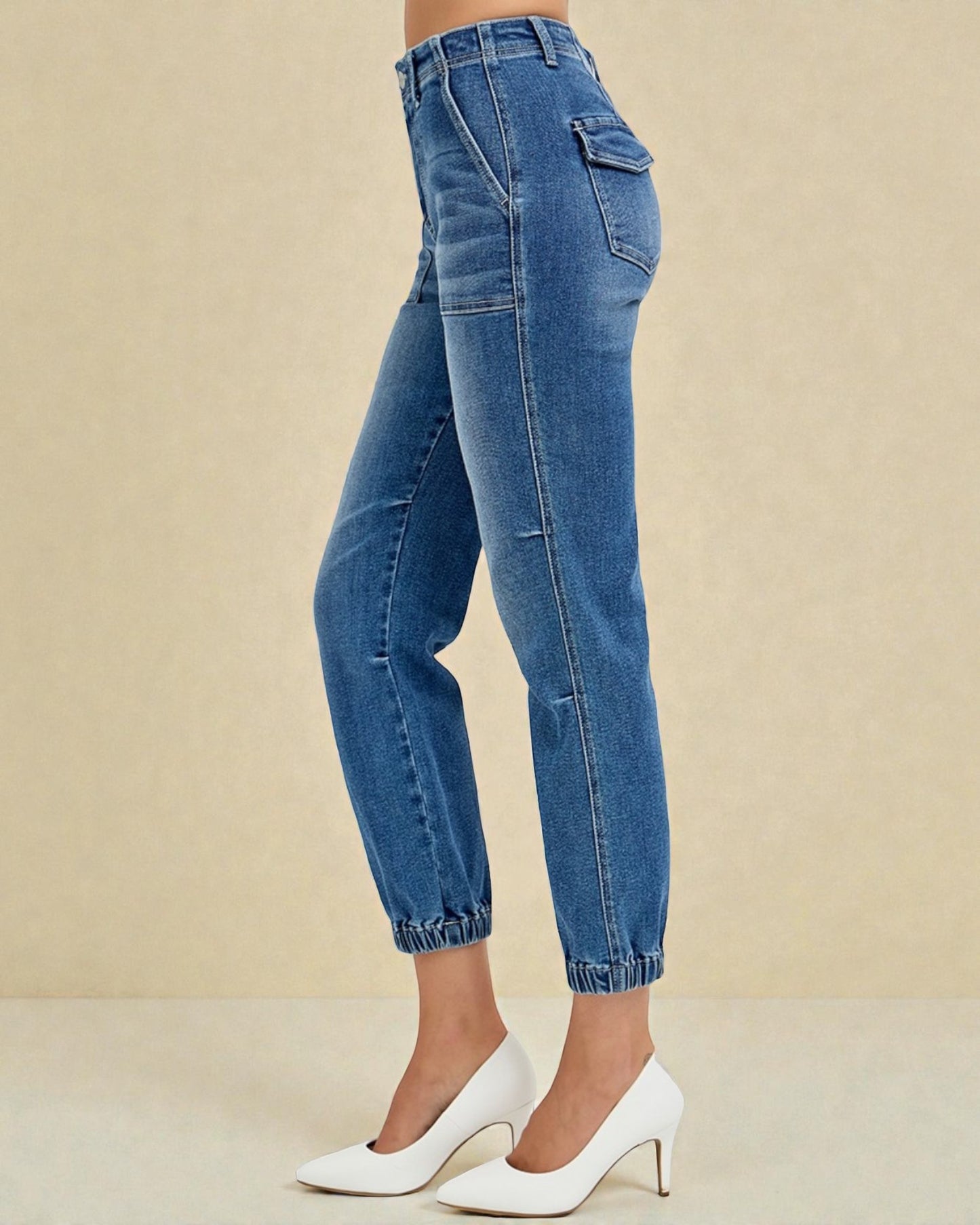 Blue jeans worn by a person on a beige background