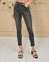 Person wearing black jeans against a beige wall