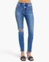 A person wearing medium-wash blue skinny jeans with distressed rips at the knees, shown from the waist down against a light gray studio background.