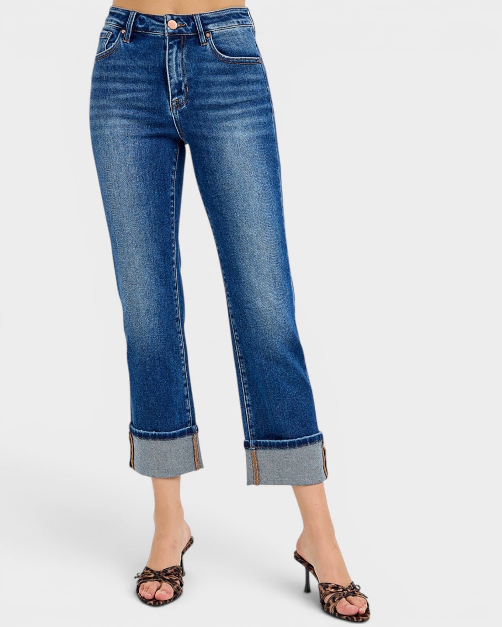 Blue jeans with rolled-up cuffs on a white background