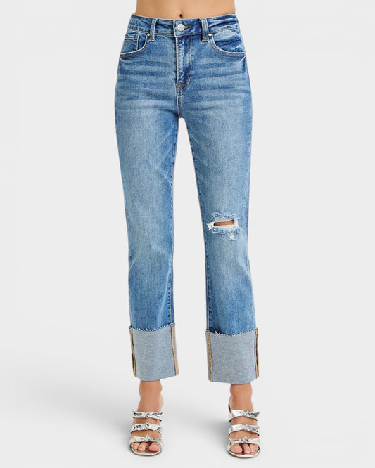 Blue jeans with a distressed design on a white background