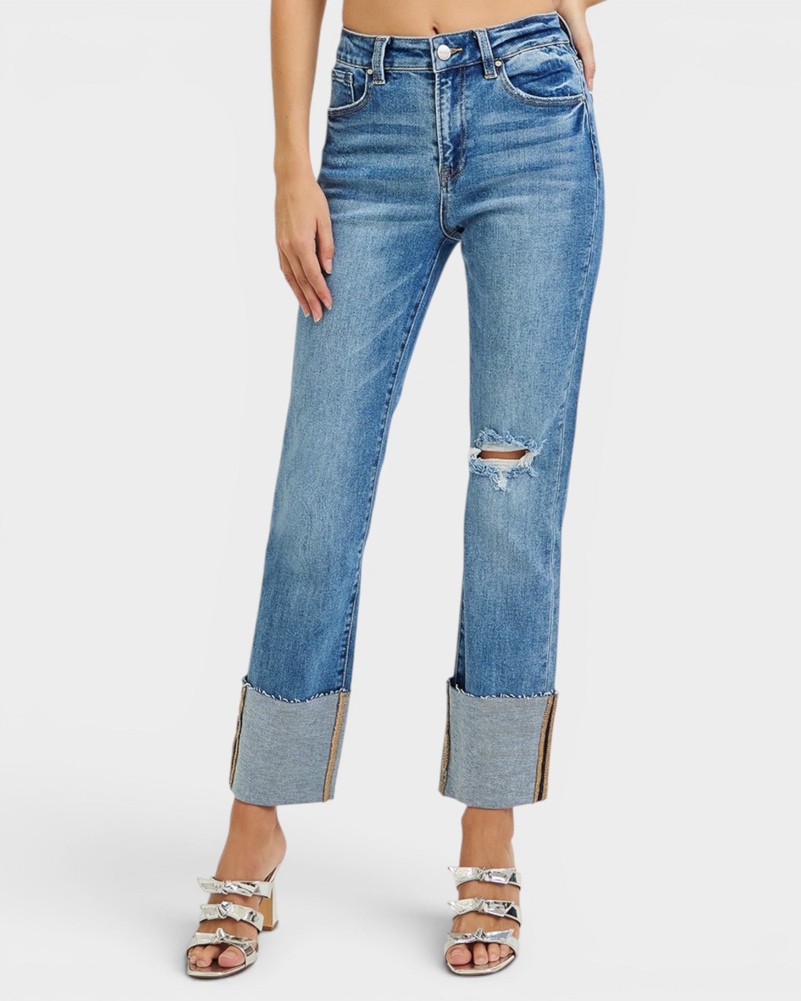 Blue jeans with a distressed look on a white background