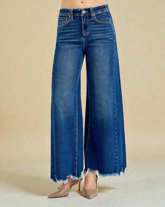 Blue wide-leg jeans on a beige background