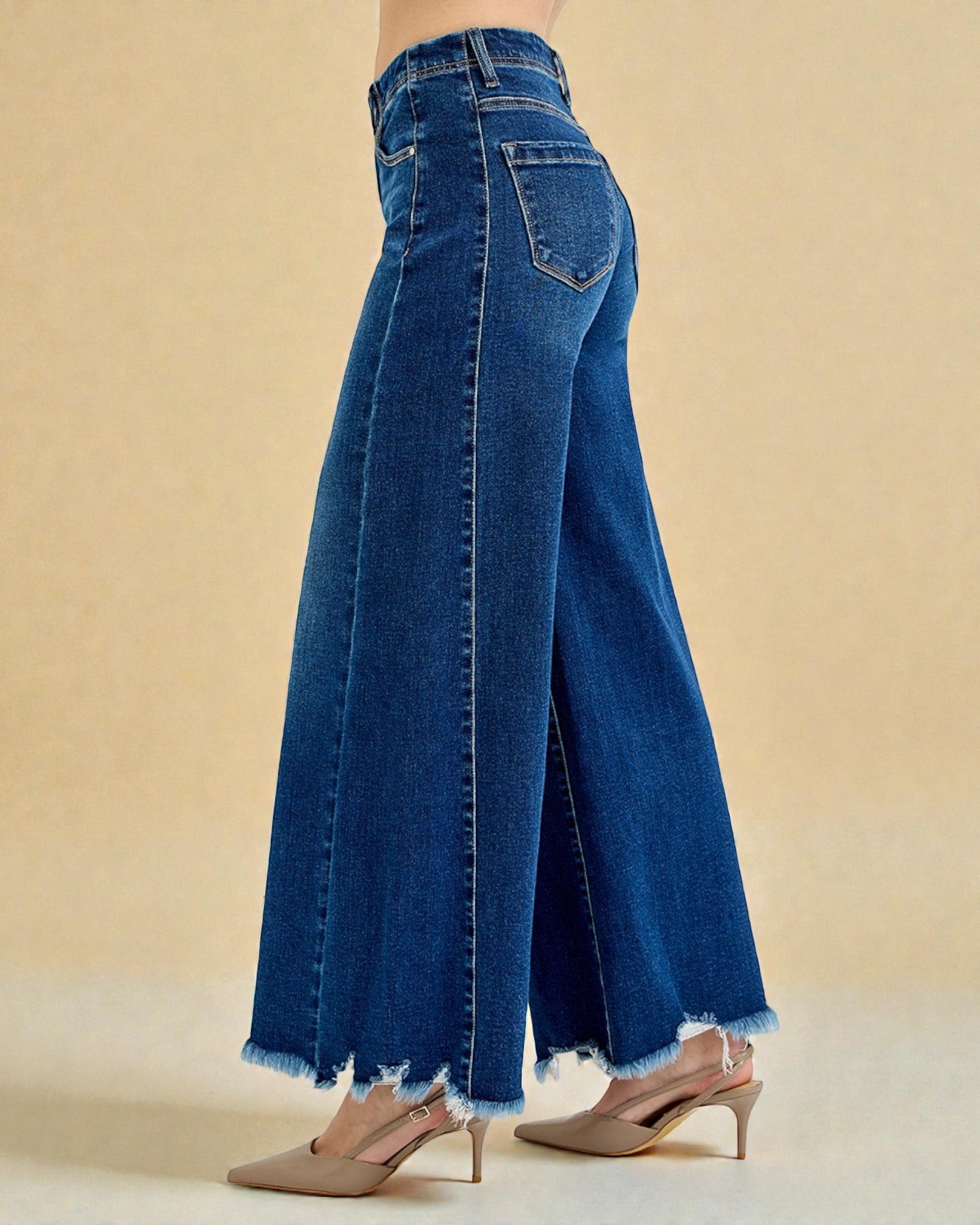 Blue wide-leg jeans on a beige background
