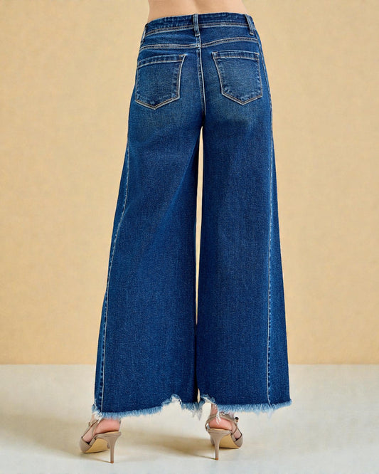 Blue wide-leg jeans on a beige background