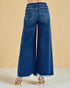 Blue wide-leg jeans on a beige background