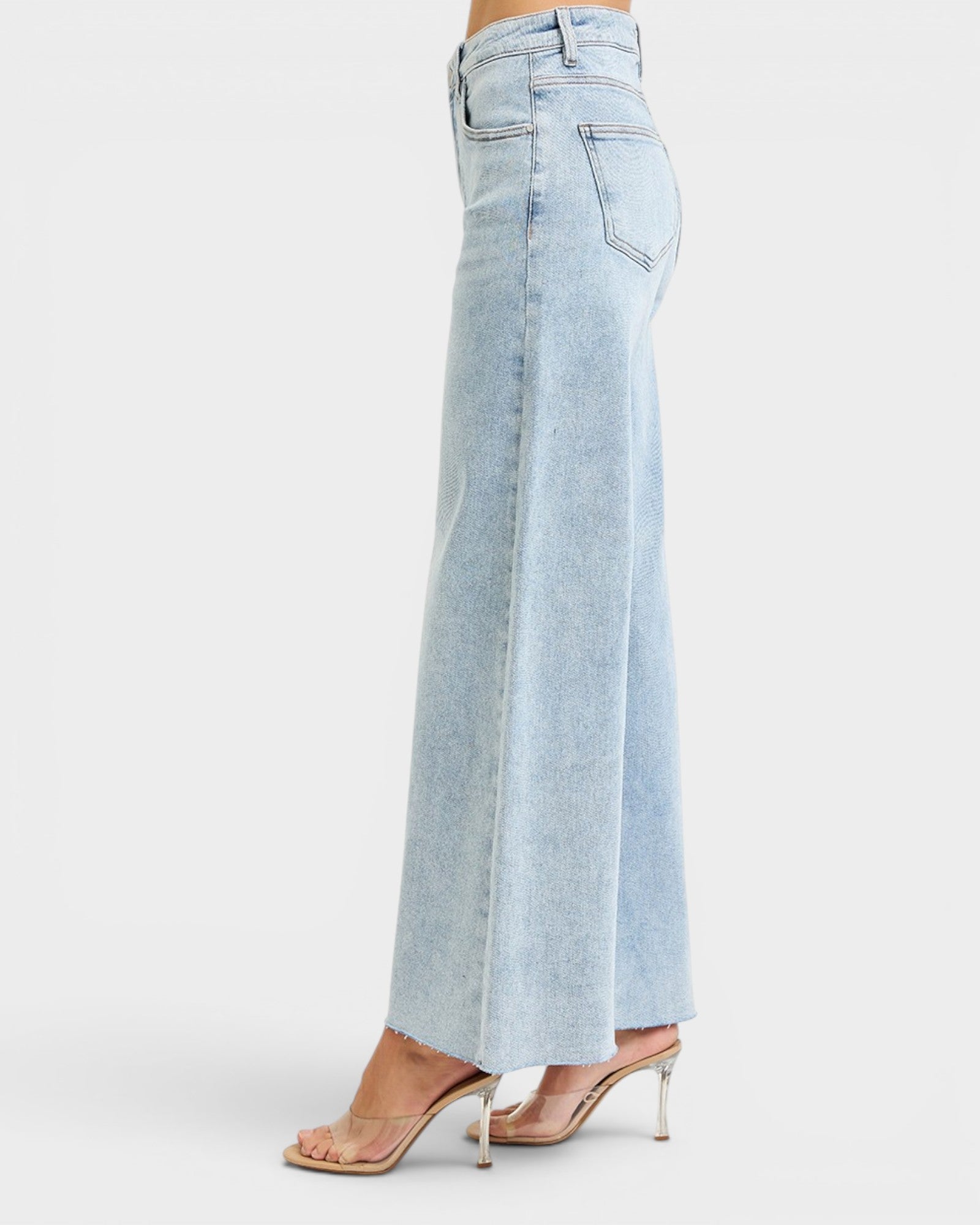 Light blue jeans worn by a person on a white background