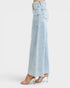 Light blue jeans worn by a person on a white background