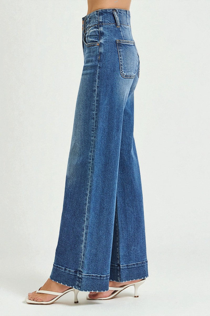 Blue wide-leg jeans worn by a person on a light gray background