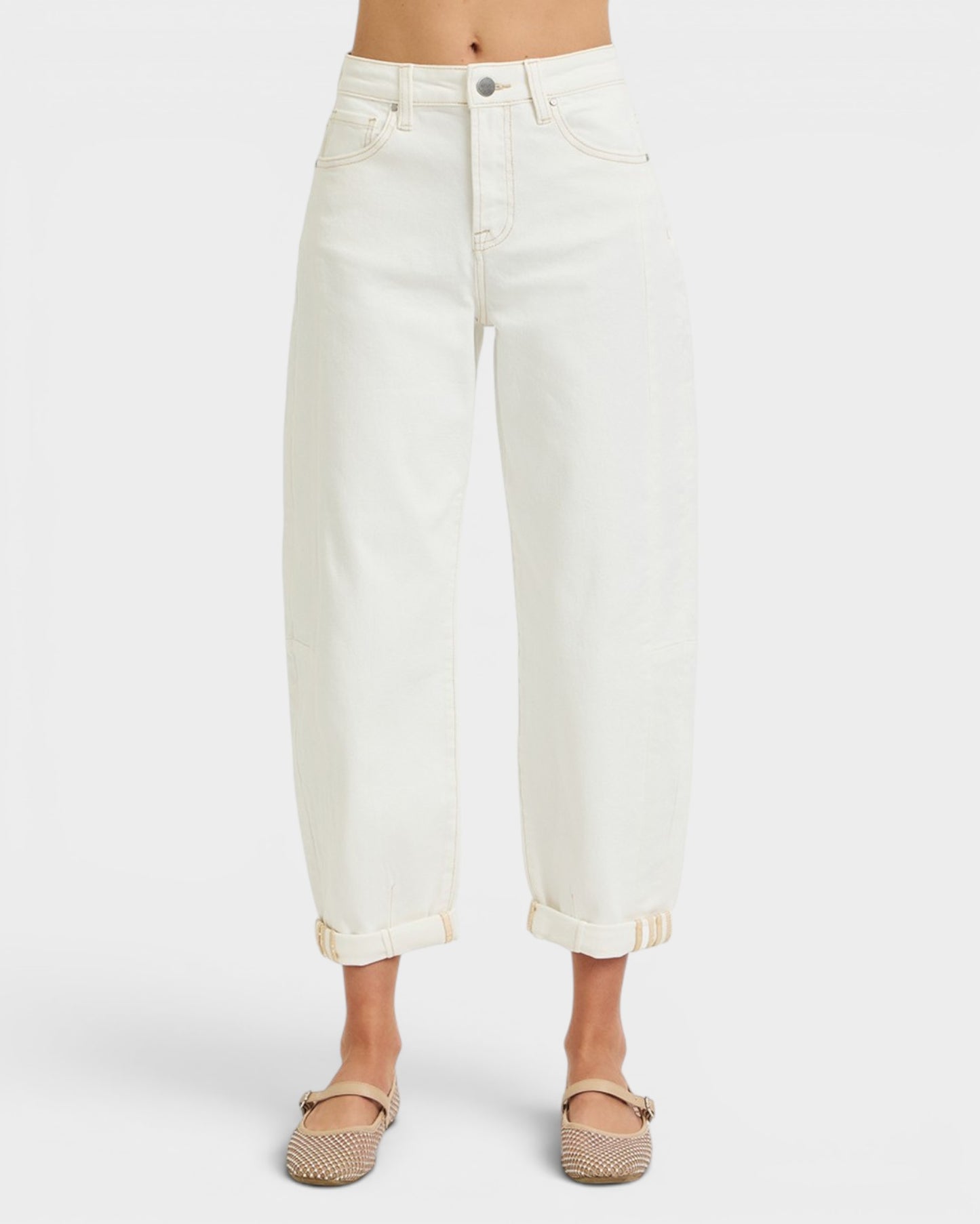 White jeans worn by a person on a white background