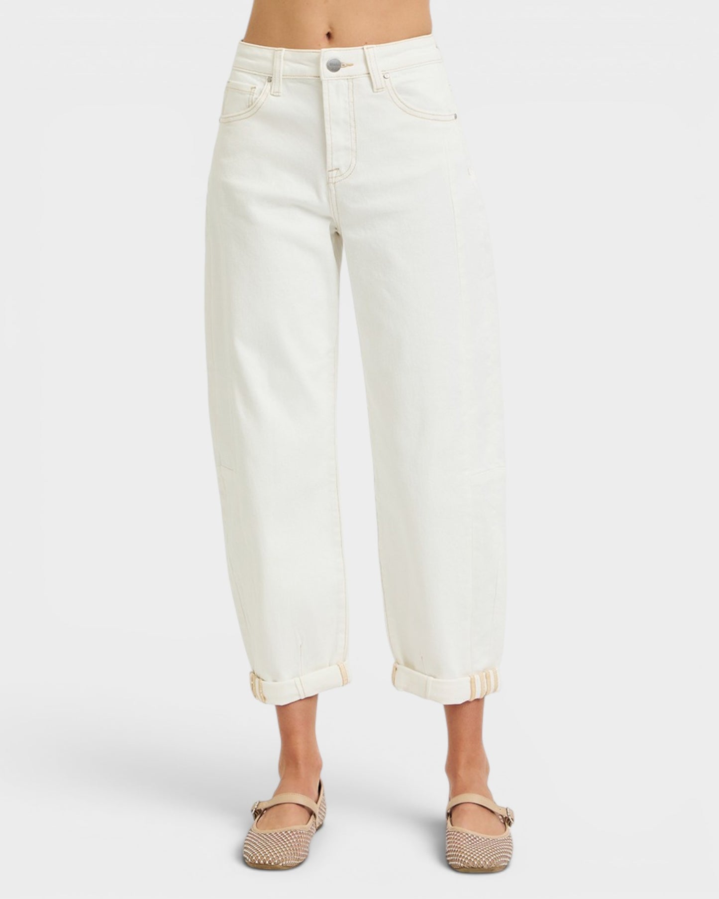 White jeans worn by a person on a white background