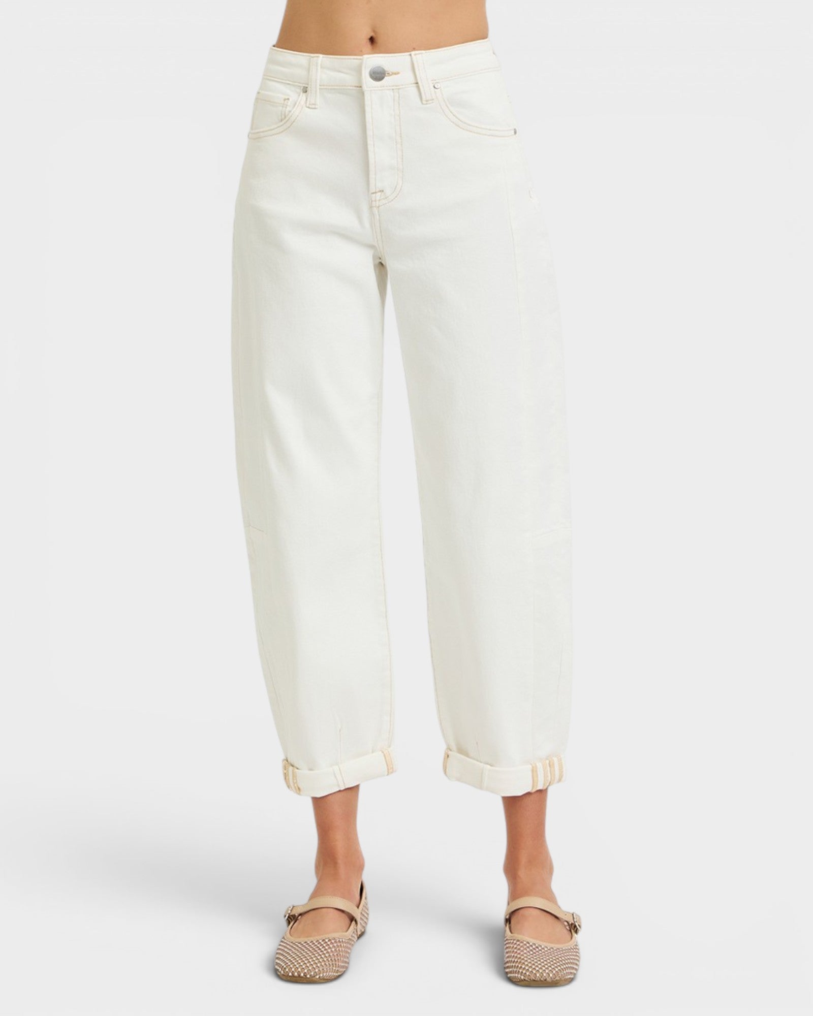 White jeans worn by a person on a white background