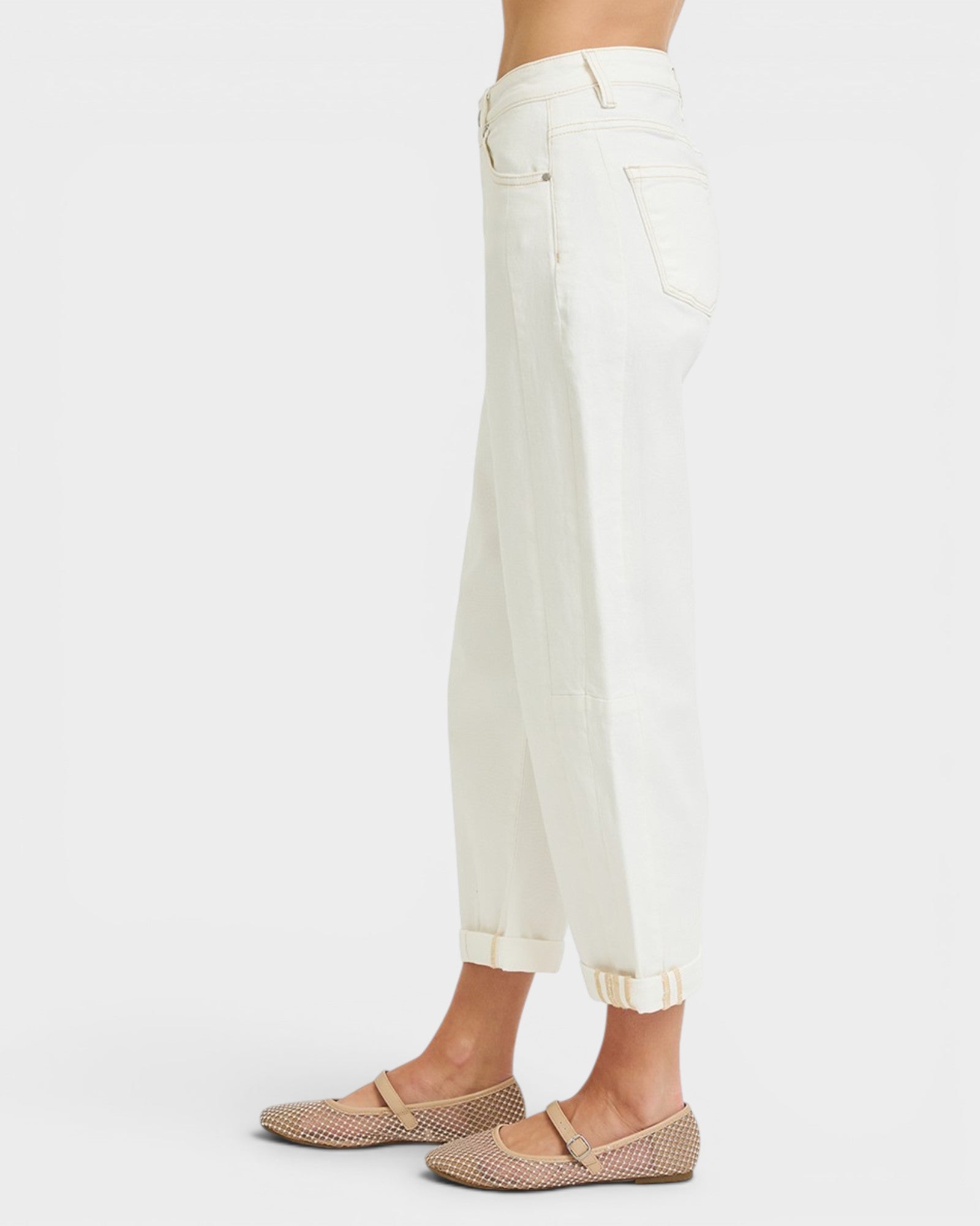 White jeans worn by a person on a white background